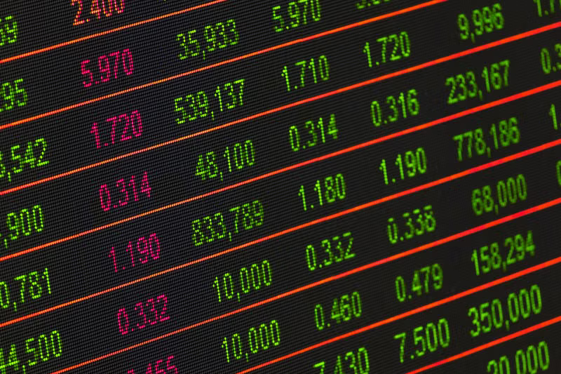 Financial planning desk with laptop and investment charts