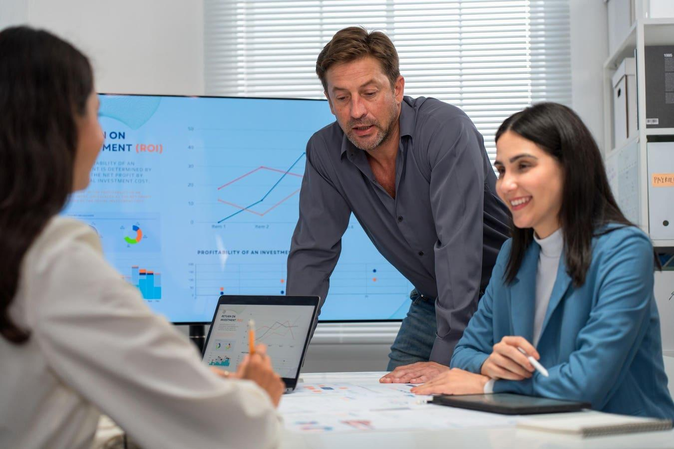 Business professionals in a collaborative portfolio review meeting